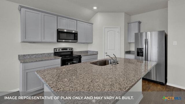 kitchen with sink, light stone counters, dark hardwood / wood-style flooring, a kitchen island with sink, and appliances with stainless steel finishes