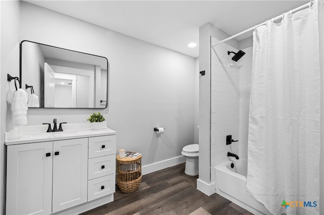 full bathroom with vanity, hardwood / wood-style floors, shower / tub combo, and toilet