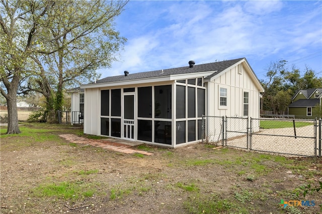 rear view of property with a sunroom