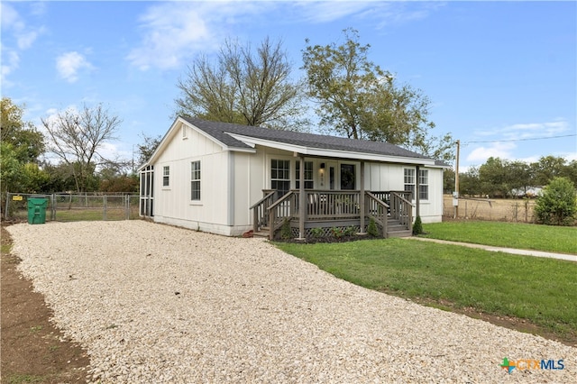 view of front of home with a porch and a front lawn