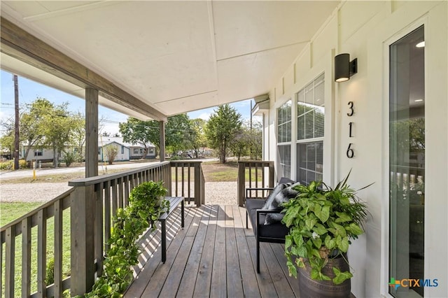 wooden terrace with a porch