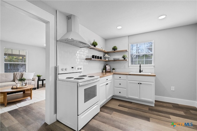 kitchen featuring sink, white electric range, hardwood / wood-style flooring, ventilation hood, and white cabinets