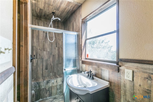 bathroom featuring walk in shower, plenty of natural light, and vanity