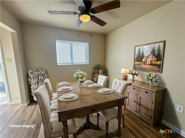 dining area with light wood-type flooring and ceiling fan