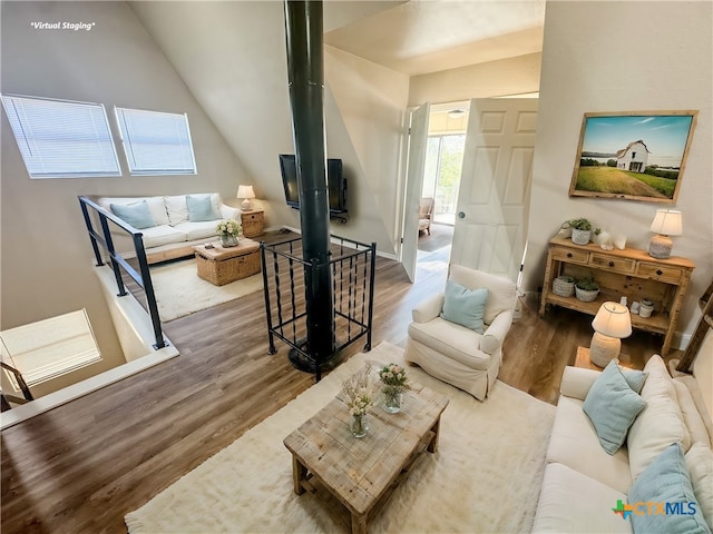 living room featuring vaulted ceiling and hardwood / wood-style flooring