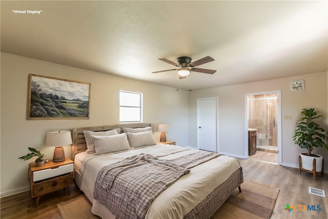 bedroom featuring connected bathroom, hardwood / wood-style flooring, and ceiling fan