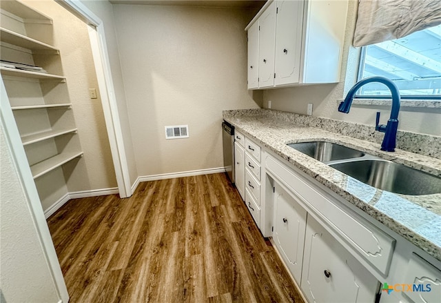 kitchen with white cabinetry, dark wood-type flooring, sink, and light stone counters