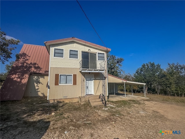 back of property featuring a carport