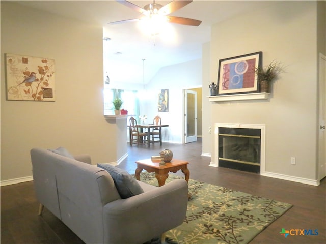 living room featuring vaulted ceiling, ceiling fan, and dark hardwood / wood-style floors