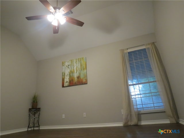 unfurnished room featuring dark hardwood / wood-style floors, ceiling fan, and vaulted ceiling