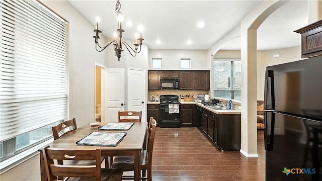 957/959 Floating Star, New Braunfels, TX 78130 - dining area featuring arched walkways, dark wood-style floors, a chandelier, and recessed lighting