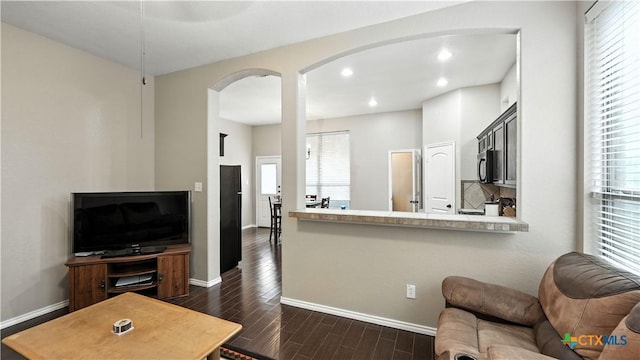 957/959 Floating Star, New Braunfels, TX 78130 - living area with dark wood-style floors, arched walkways, healthy amount of natural light, and recessed lighting