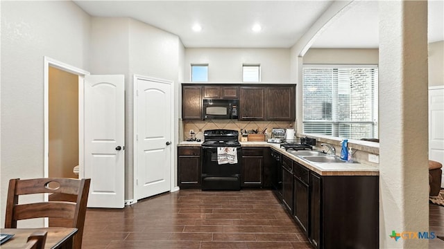 957/959 Floating Star, New Braunfels, TX 78130 - kitchen featuring black appliances, dark brown cabinets, decorative backsplash, light countertops, and dark wood-style floors