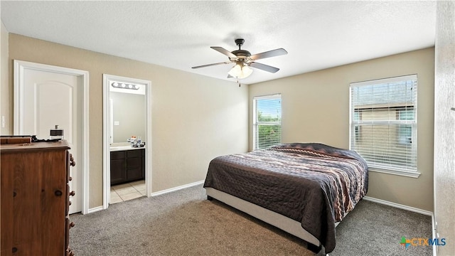 957/959 Floating Star, New Braunfels, TX 78130 - bedroom with light colored carpet, ensuite bath, ceiling fan, and a textured ceiling