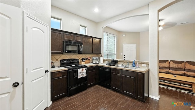 957/959 Floating Star, New Braunfels, TX 78130 - kitchen featuring black appliances, arched walkways, dark brown cabinets, tasteful backsplash, and dark wood finished floors