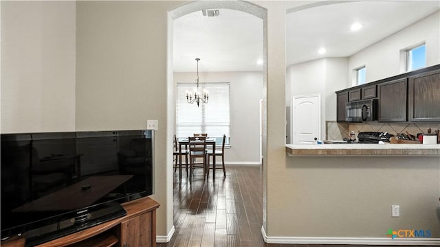957/959 Floating Star, New Braunfels, TX 78130 - kitchen with black microwave, backsplash, dark wood-type flooring, dark brown cabinets, and light countertops