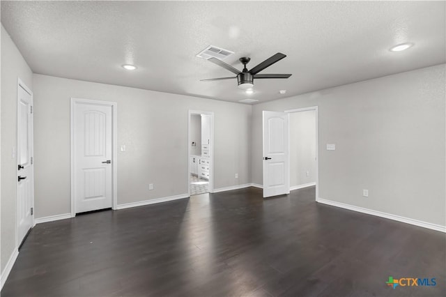 spare room featuring ceiling fan, dark hardwood / wood-style flooring, and a textured ceiling