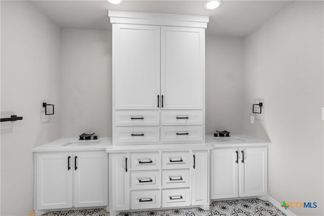 bathroom featuring tile patterned flooring and vanity