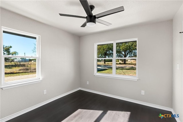 unfurnished room with ceiling fan and dark hardwood / wood-style floors