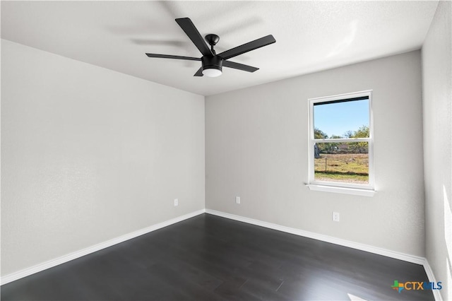 empty room with ceiling fan and dark hardwood / wood-style flooring