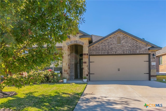 view of front of home with a garage and a front lawn