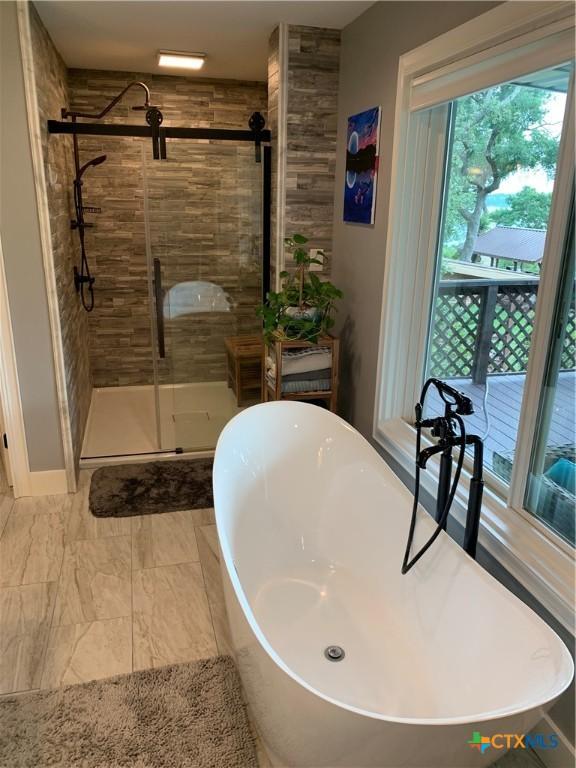 164 Buck Ln, Belton, TX 76513 - bathroom with a stall shower and a freestanding bath