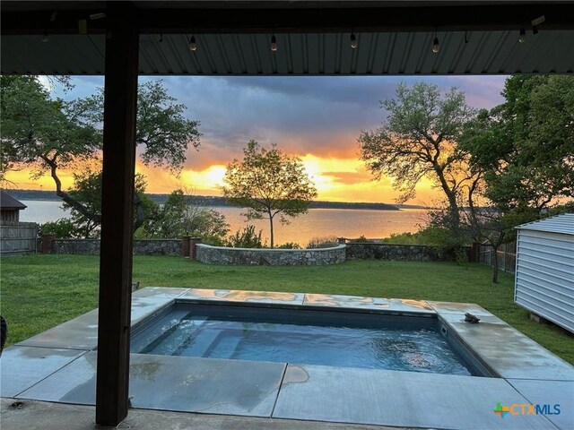 164 Buck Ln, Belton, TX 76513 - pool at dusk featuring an in-ground hot tub and a water view