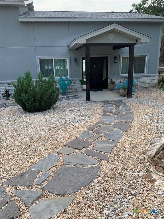 164 Buck Ln, Belton, TX 76513 - entrance to property featuring stone siding, stucco siding, and a shingled roof