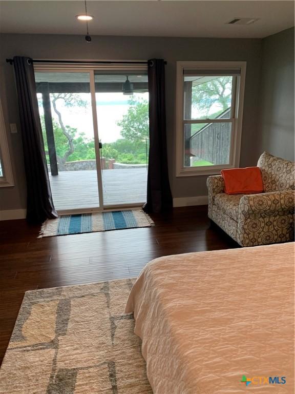 164 Buck Ln, Belton, TX 76513 - bedroom with baseboards, access to exterior, and wood finished floors