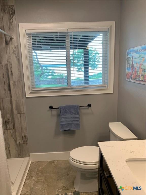 164 Buck Ln, Belton, TX 76513 - full bathroom featuring toilet, vanity, baseboards, and tiled shower