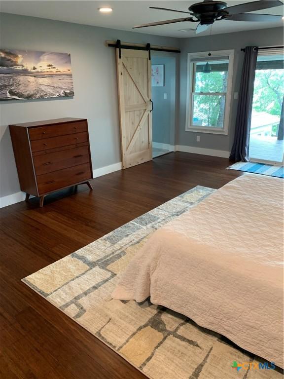164 Buck Ln, Belton, TX 76513 - bedroom with a barn door, baseboards, access to outside, and recessed lighting