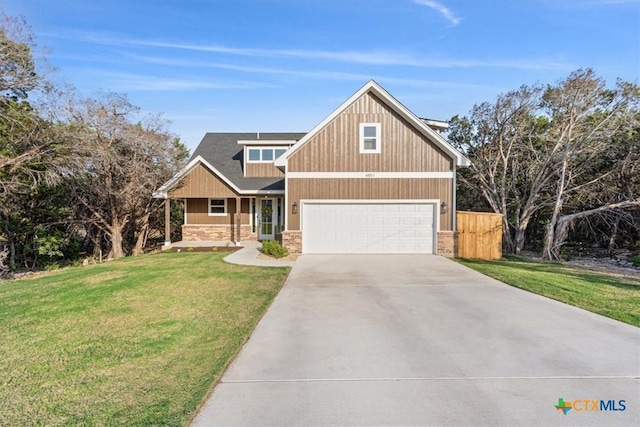 4851 Goliad Dr, Temple, TX 76502 - craftsman inspired home featuring an attached garage, driveway, a front yard, and stone siding