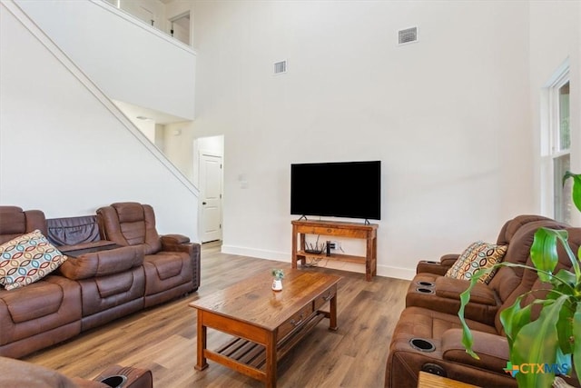 4851 Goliad Dr, Temple, TX 76502 - living room featuring visible vents, a high ceiling, baseboards, and wood finished floors