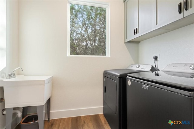 4851 Goliad Dr, Temple, TX 76502 - washroom featuring baseboards, independent washer and dryer, wood finished floors, and cabinet space