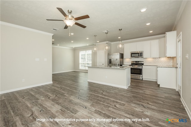 kitchen with white cabinetry, appliances with stainless steel finishes, dark hardwood / wood-style floors, and a kitchen island with sink