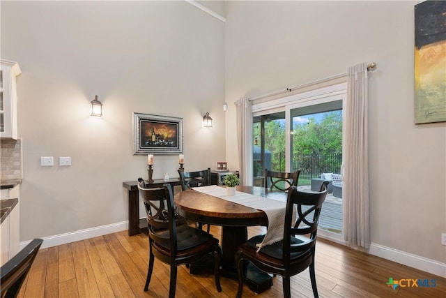 260 County Road 413, Spicewood, TX 78669 - dining room with baseboards, light wood-style flooring, and a high ceiling