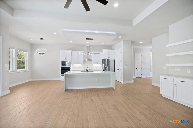 20029 Continental Dr, Lago Vista, TX 78645 - kitchen featuring stainless steel appliances, a sink, ceiling fan, tasteful backsplash, and hanging light fixtures