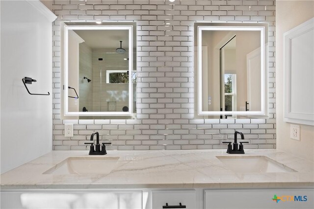 20029 Continental Dr, Lago Vista, TX 78645 - bathroom featuring double vanity, backsplash, and a tile shower