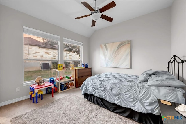 bedroom with ceiling fan, carpet floors, and vaulted ceiling