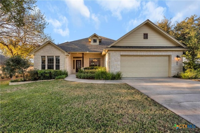 view of front of house featuring a front yard and a garage