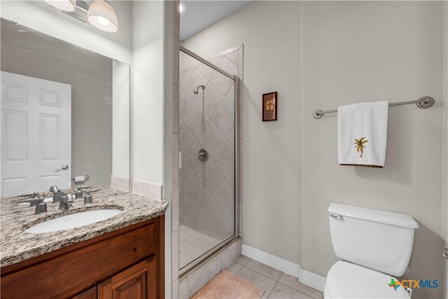 bathroom with toilet, vanity, tile patterned floors, and a shower with shower door