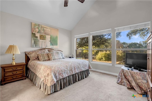 bedroom with ceiling fan, carpet floors, and high vaulted ceiling