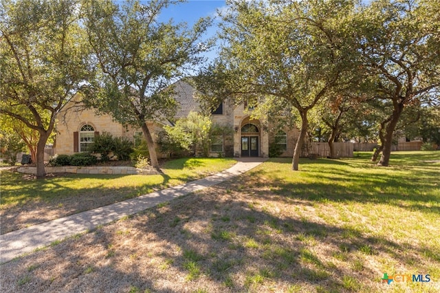 mediterranean / spanish house featuring a front yard