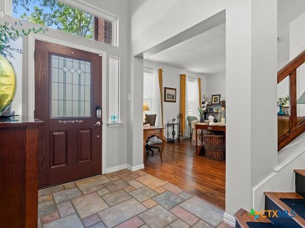 405 Arapaho Dr, Harker Heights, TX 76548 - entrance foyer with stone finish floors and stairs