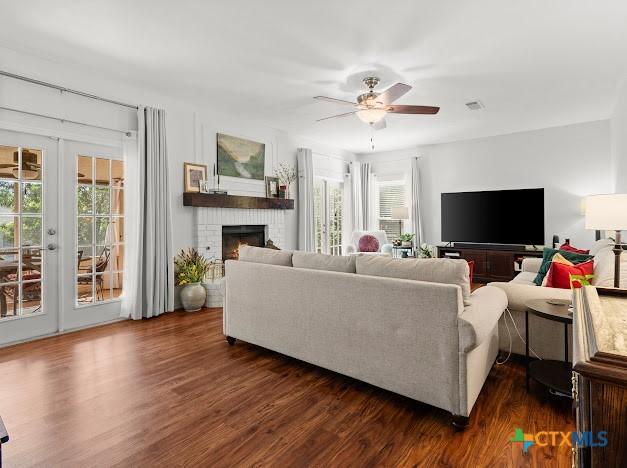 405 Arapaho Dr, Harker Heights, TX 76548 - living area featuring a ceiling fan, dark wood-style floors, french doors, and a fireplace