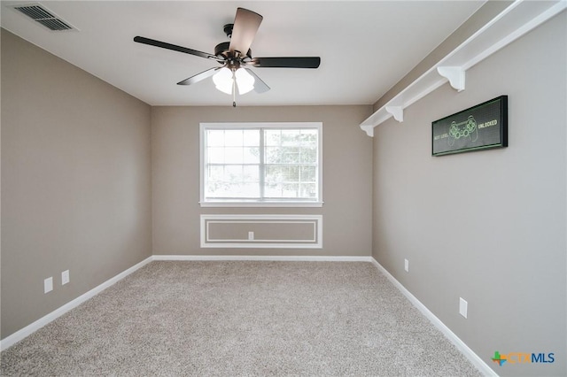 unfurnished room featuring visible vents, carpet, ceiling fan, and baseboards