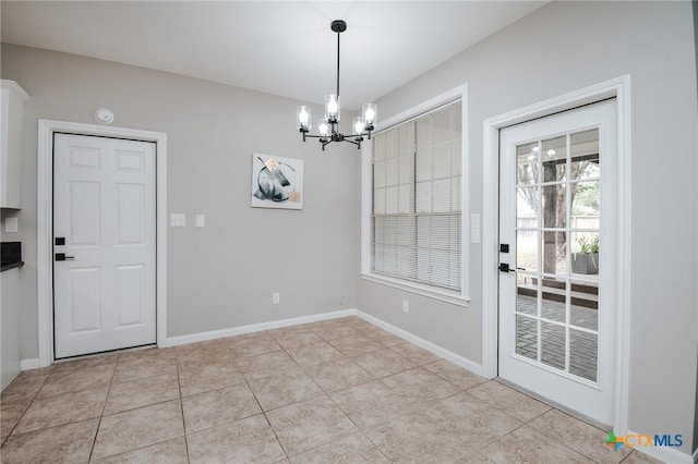 unfurnished dining area with baseboards, light tile patterned flooring, and a notable chandelier
