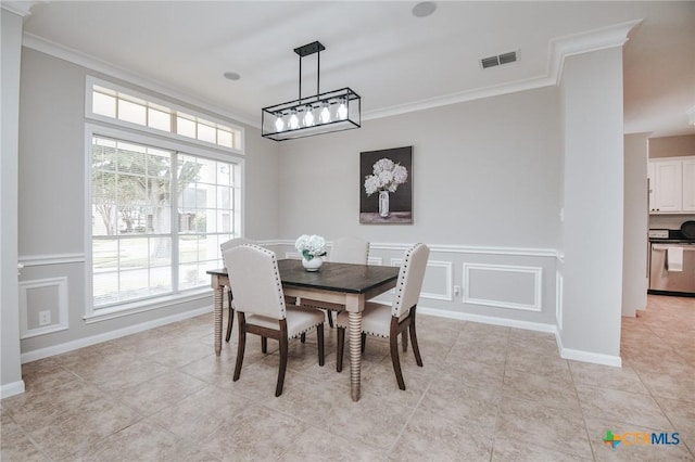 dining area featuring crown molding, light tile patterned flooring, a decorative wall, baseboards, and visible vents