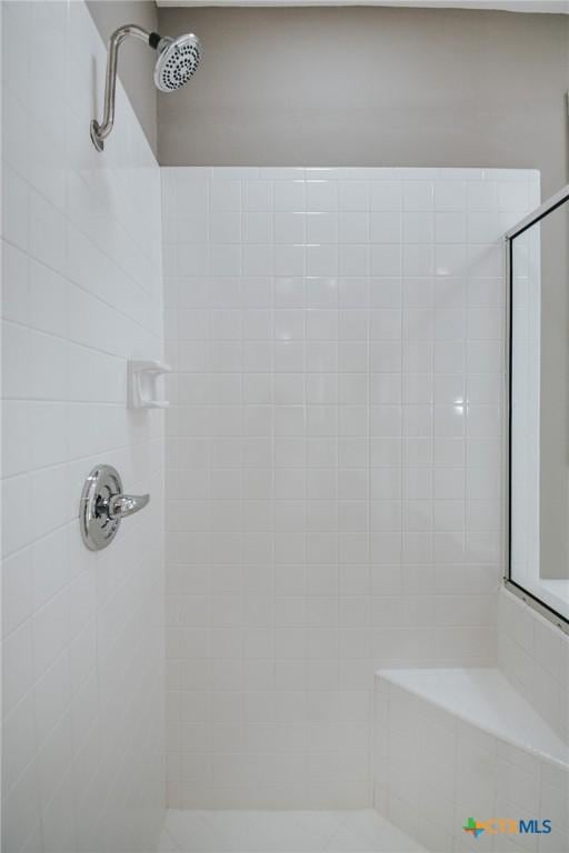bathroom with a tile shower