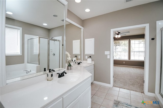 bathroom featuring baseboards, ceiling fan, a shower stall, and tile patterned floors